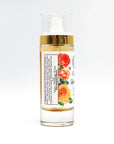 Glass skincare serum bottle with gold top, floral label, and visible ingredient list