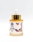 Glass dropper bottle of Golden Nectar serum with gold cap, hummingbird artwork, and 528Hz label