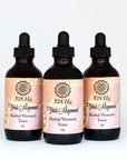 Three bottles of Total Alignment herbal women's tonic with dropper lids on white background