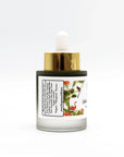 Glow serum dropper bottle with gold cap, botanical label, and organic skincare ingredients