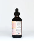 Amber glass dropper bottle of women's herbal tonic tincture with ingredient label